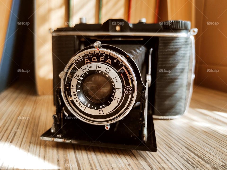 an old camera on the books