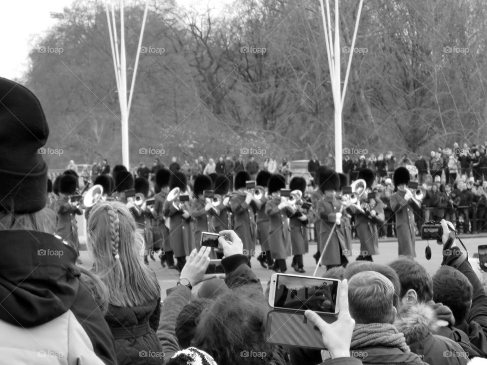Buckingham Palace - London. Change of guard in front of Buckingham Palace, London UK... Contrast between old and new. 