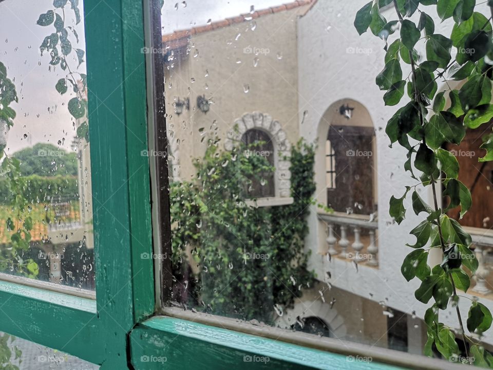 Vintage window with rain drop and reflexion on glass.
