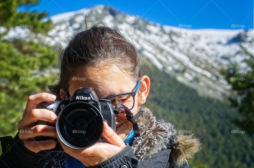 Young girl takes photos with her camera 