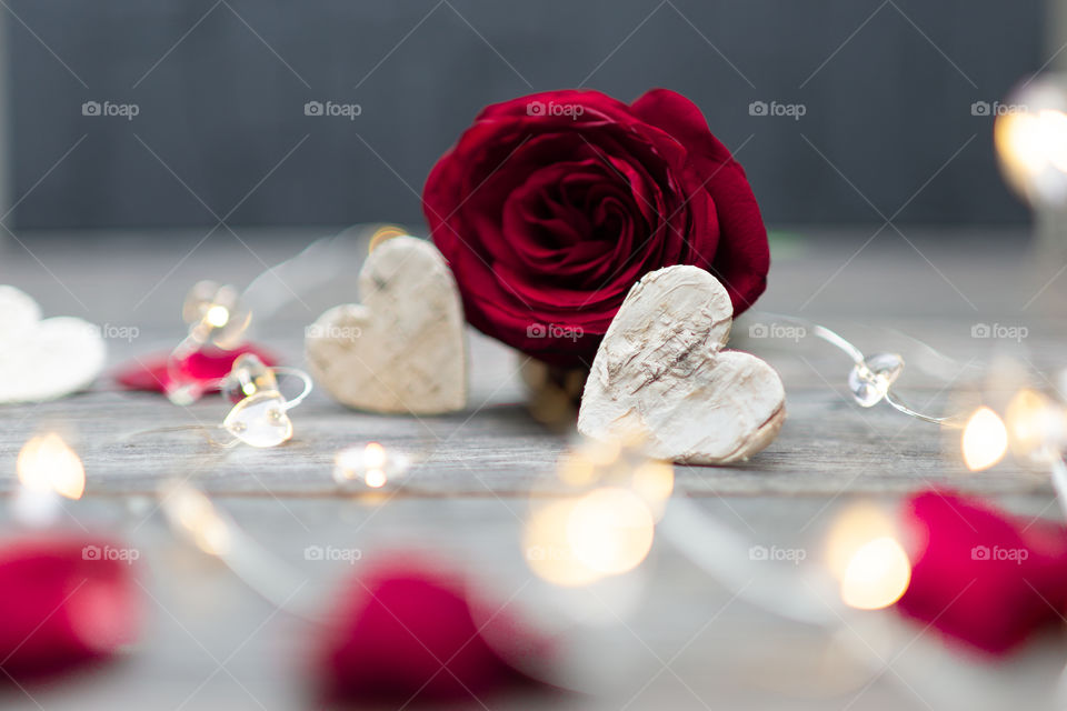 two hearts in front of a red rose