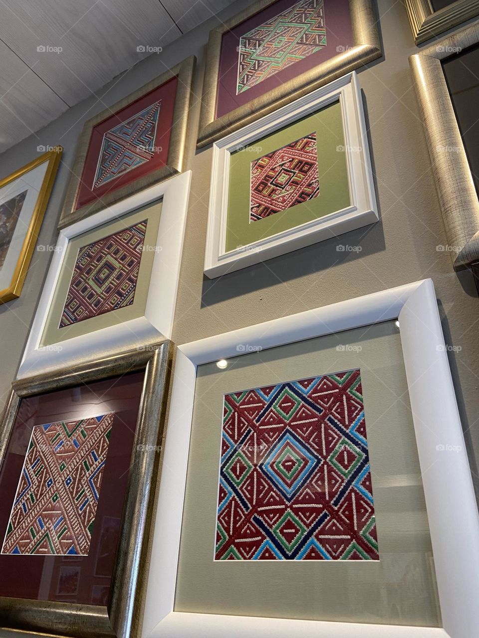 Colorful Croatian needle work in frames.