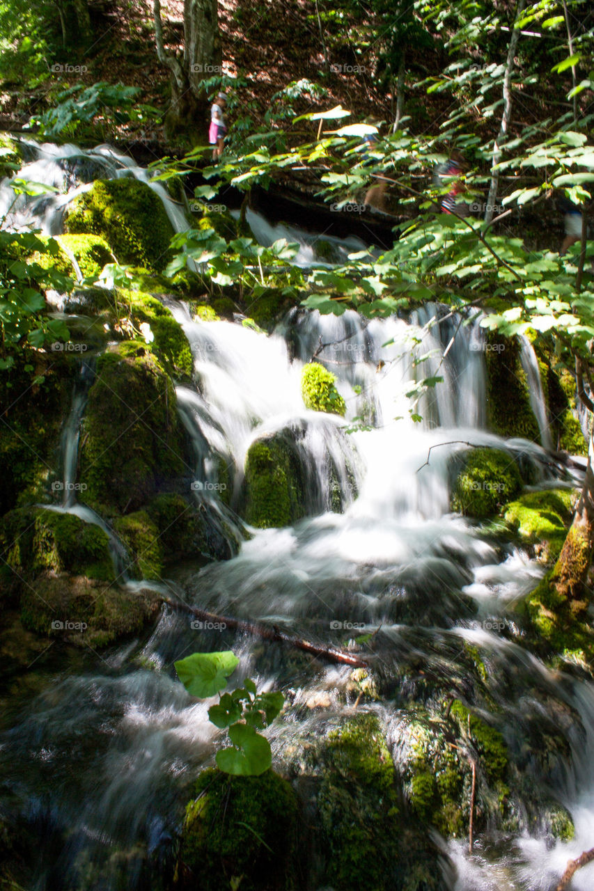 View of waterfall flowing through rock