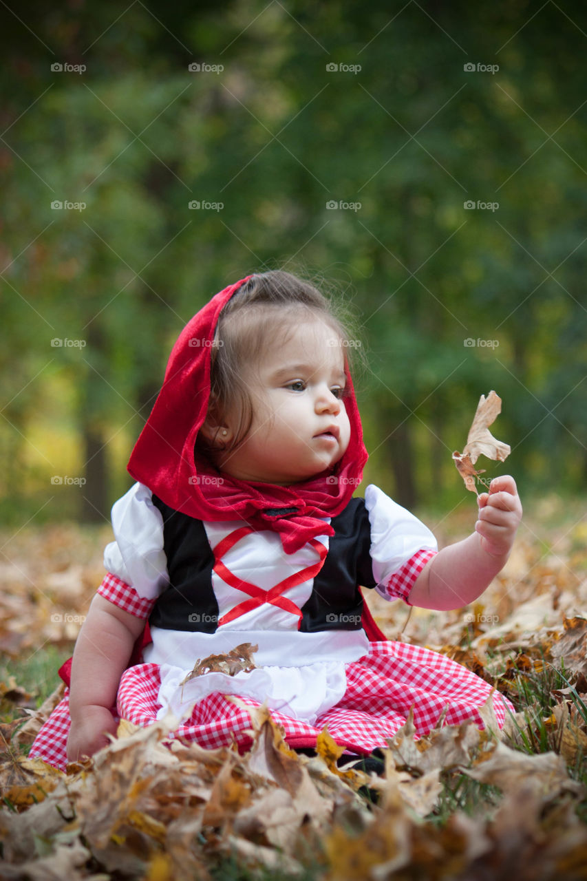 Girl sitting in garden during autumn