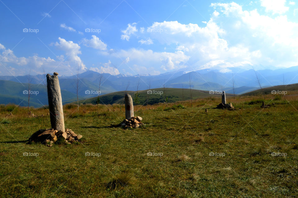 Menhirs in the mountains of the north caucasus on a cloudy summer day. Caucasus, Russia