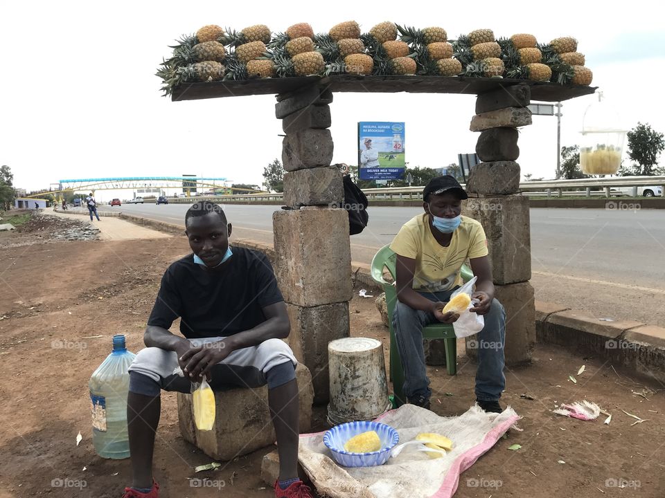 Photo of pineapples ready for sale in a busy superhighway .This is the best place where one can get sweet pineapples in Kenya.Photo taken by me and my best friends as we had a tour there and also we wanted to buy for making pineapple juices