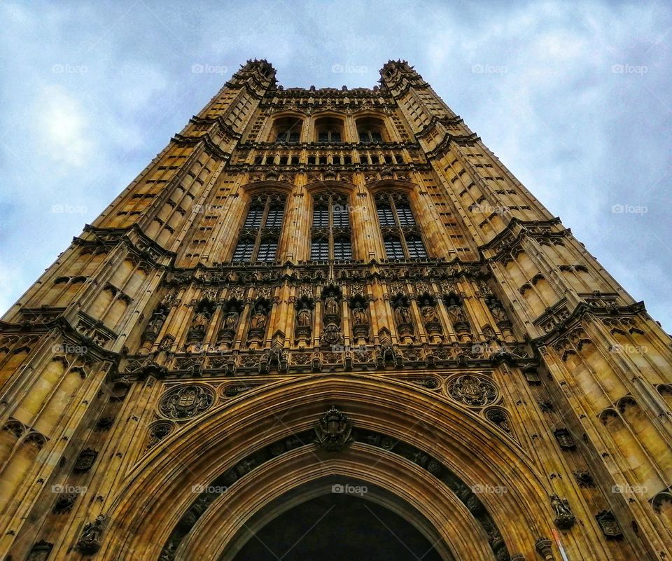 A photo of the Westminster House of Parliament captured from beneath with all its beautiful structure and architecture