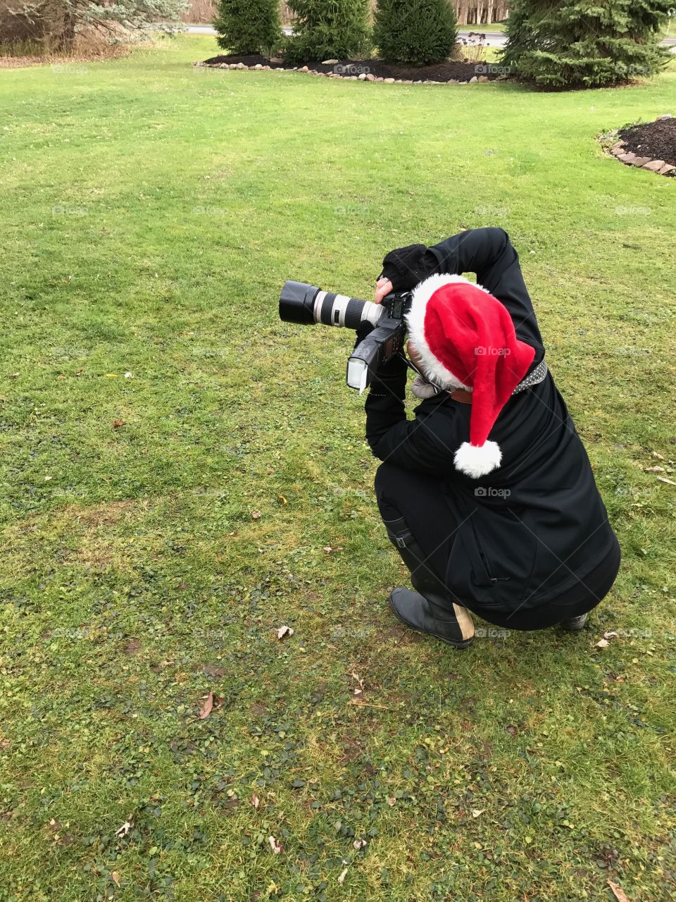 Taking photos of Santa wearing a Santa hat