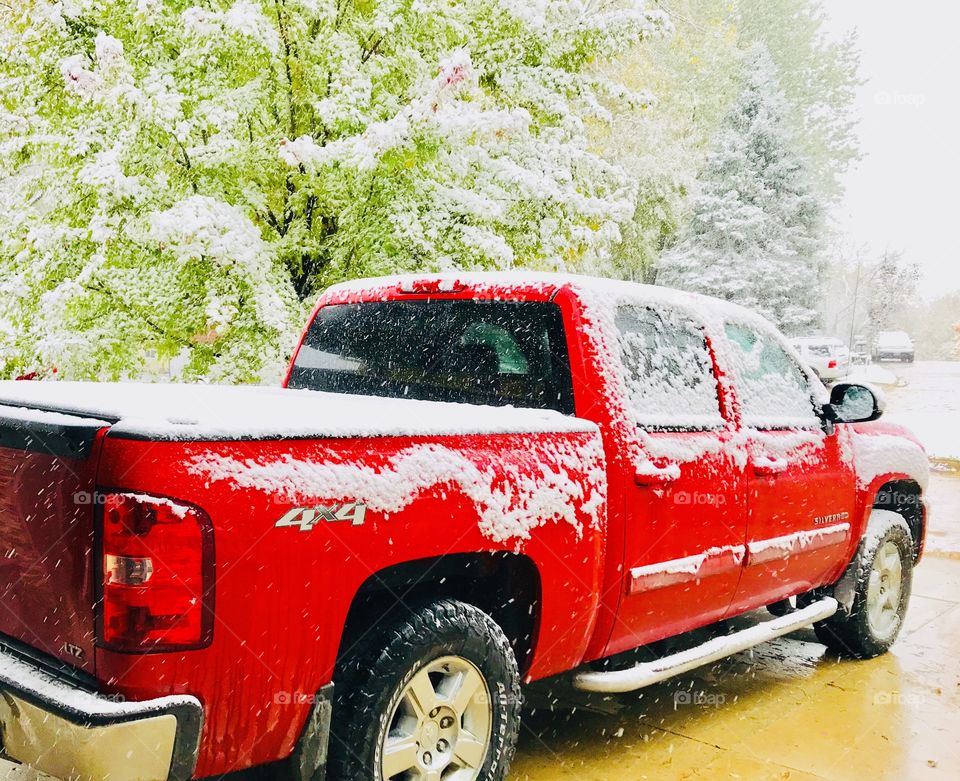 Cold stark winter time with snow covered surfaces including vehicles making everything look white! 