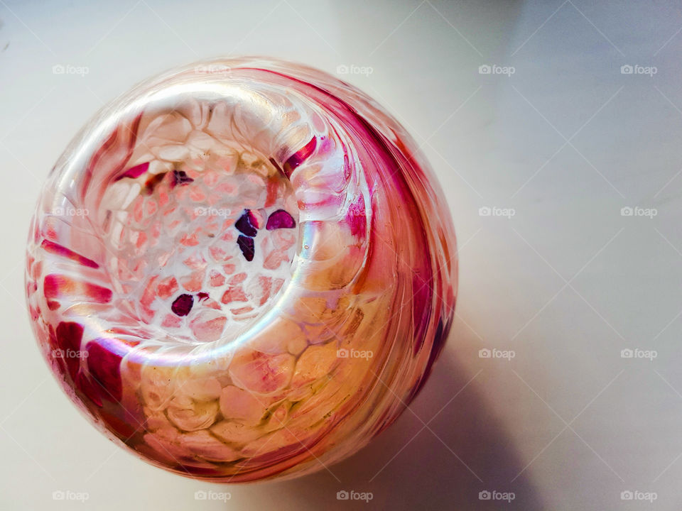 Multiple pink swirled glass ball on a white background.