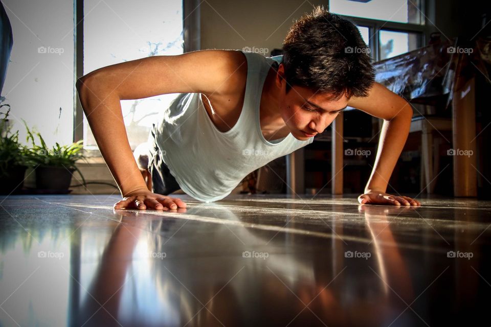 Young man is doing pushups