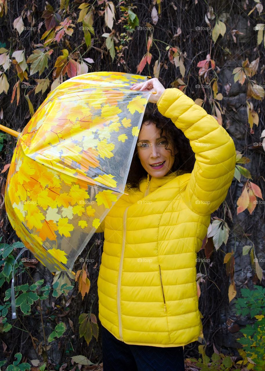 Woman with Umbrella on Autumn Background