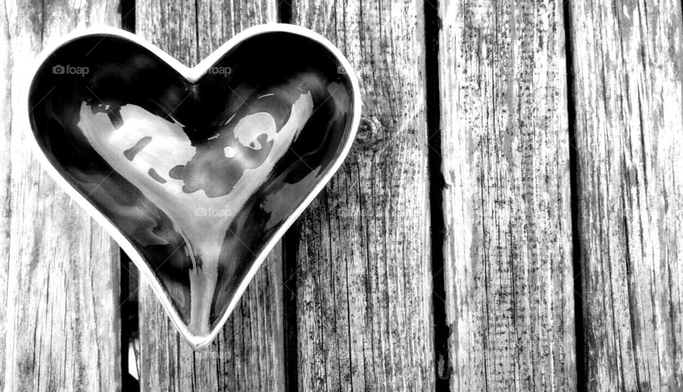 love heart. glass love heart in black and white with wood grain background 