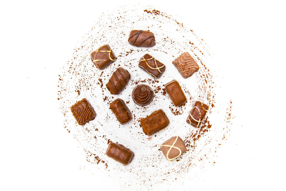 Sweet tooth! I love chocolates. Flat lay image of chocolates coated in cocoa on a white background decorated in a circle.