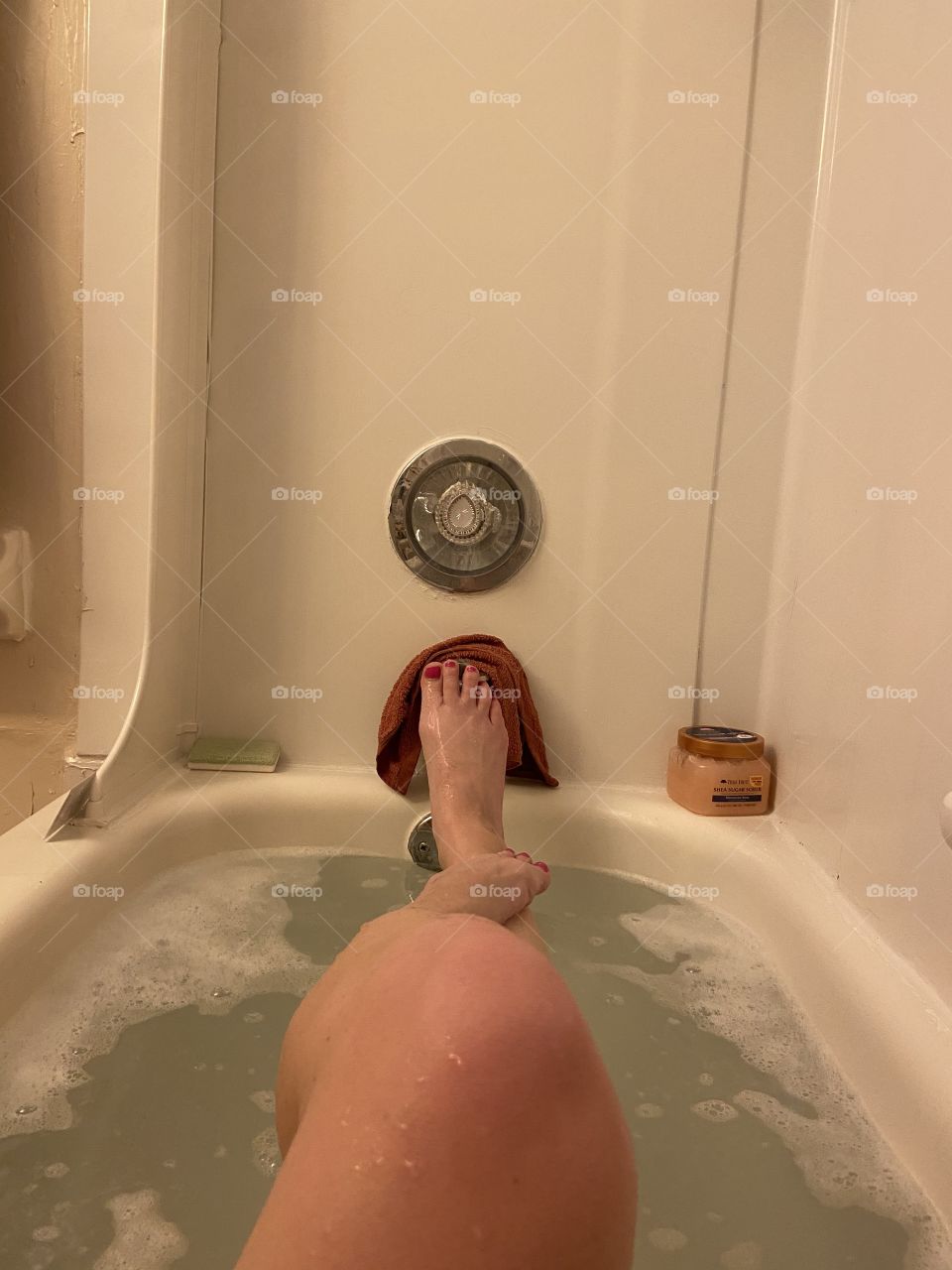 Feet and legs in the tub