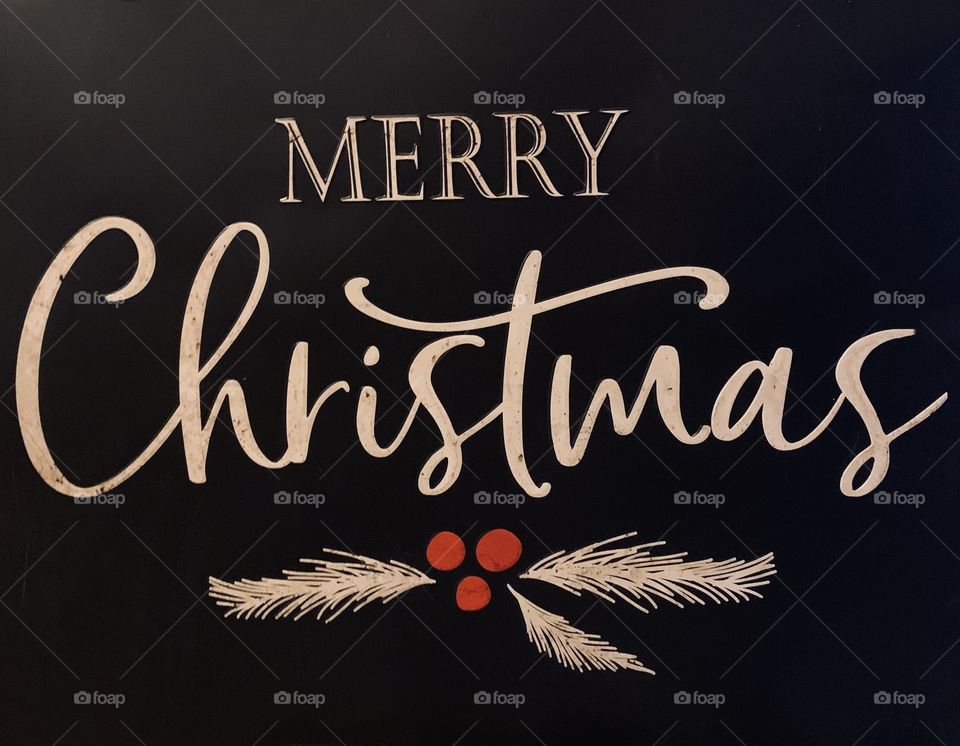 Merry Christmas sign with red holly berries 