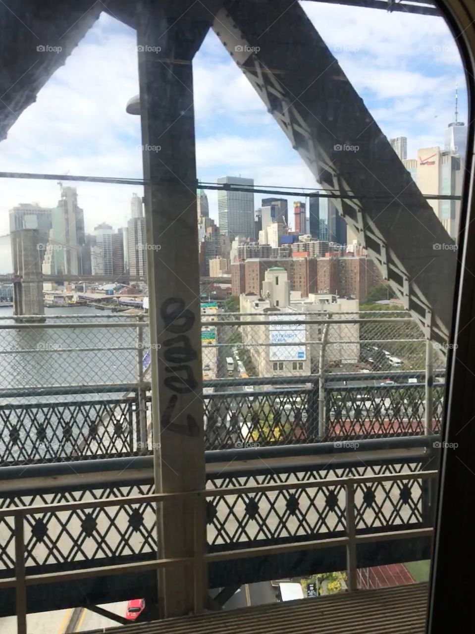 Manhattan with Brooklyn bridge from train on Manhattan bridge