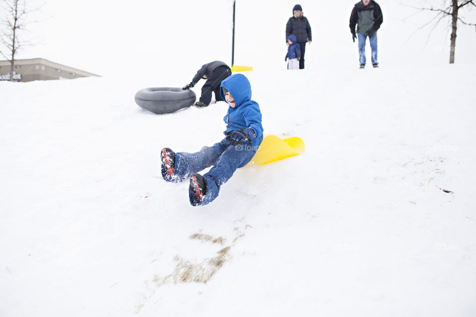 Boy flying through the air in the snow 