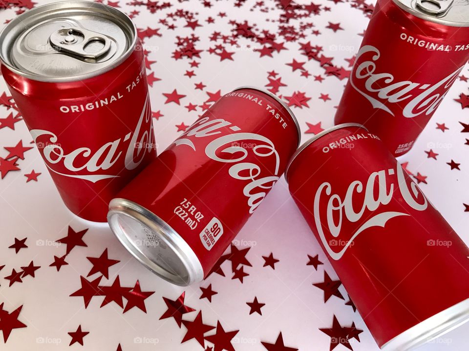 Coca Cola on a white background with red stars