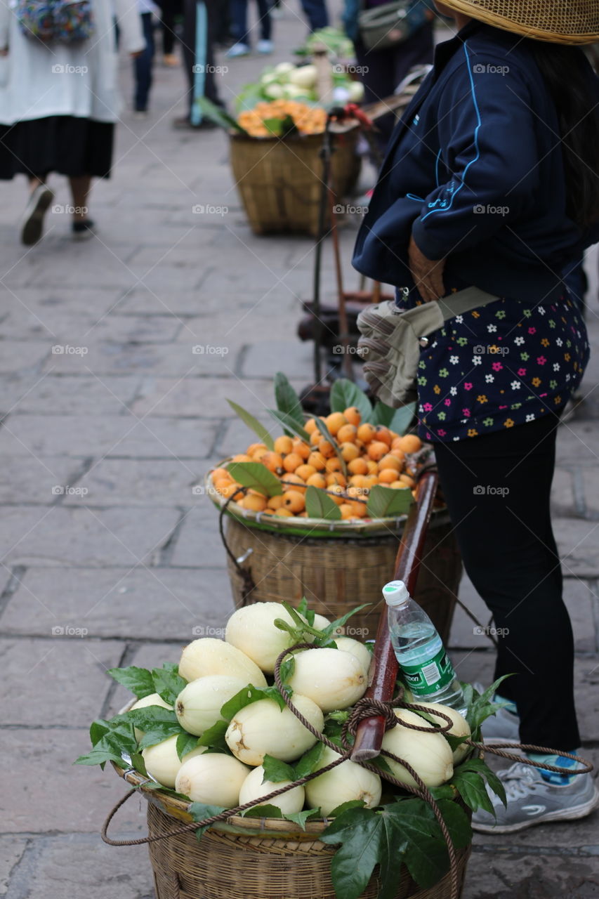 The woman sale some fruit on the street in china 
