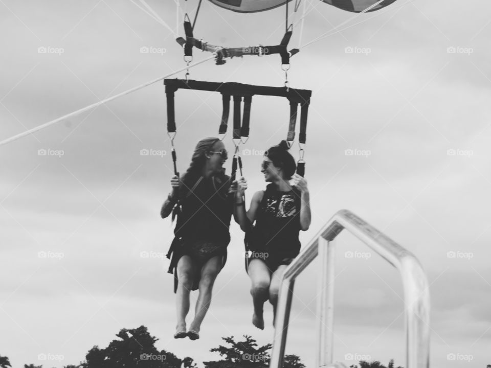 Female friends enjoying paragliding