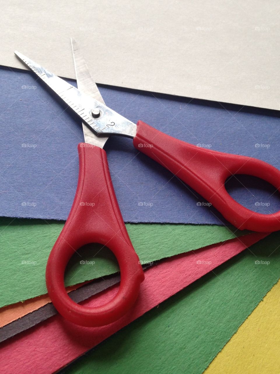 Tinted paper with red scissor