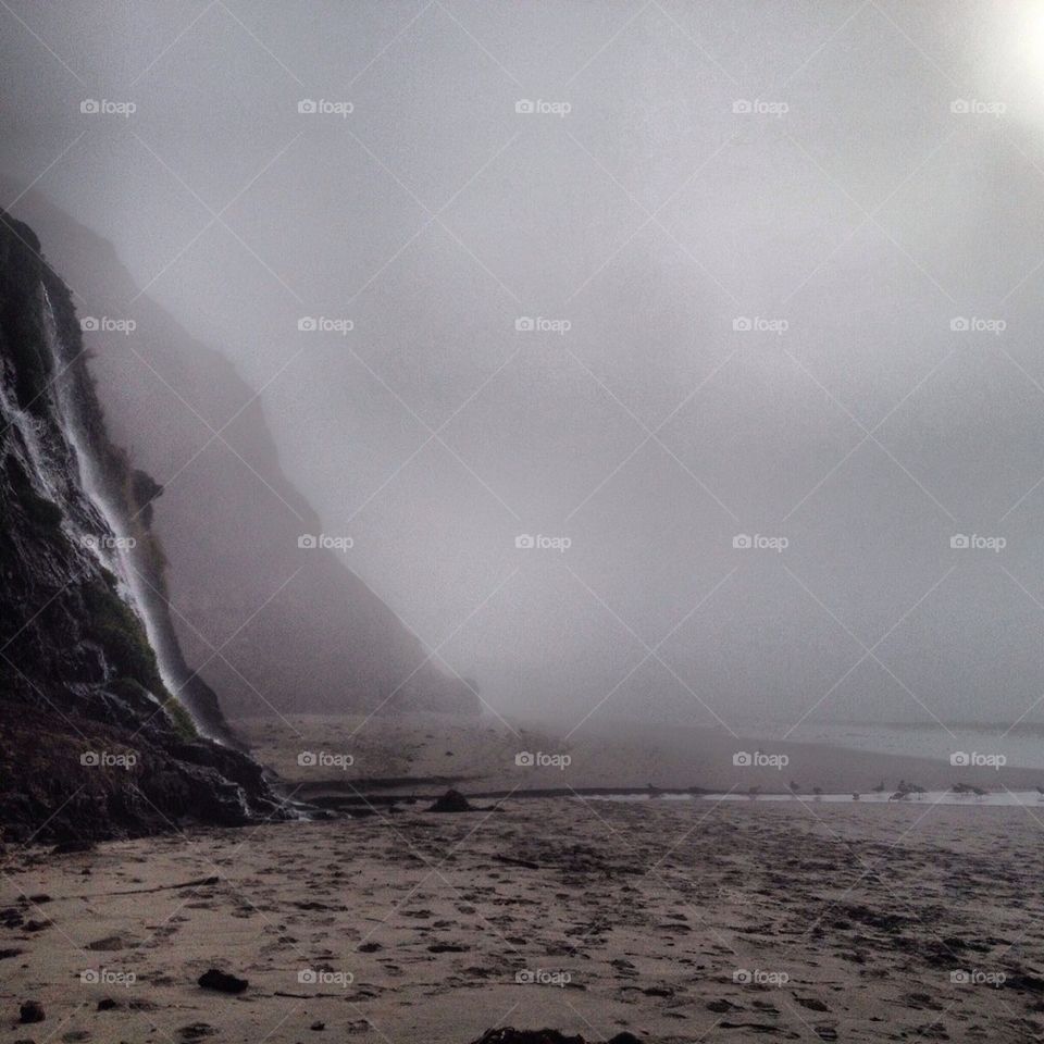 Misty beach waterfall