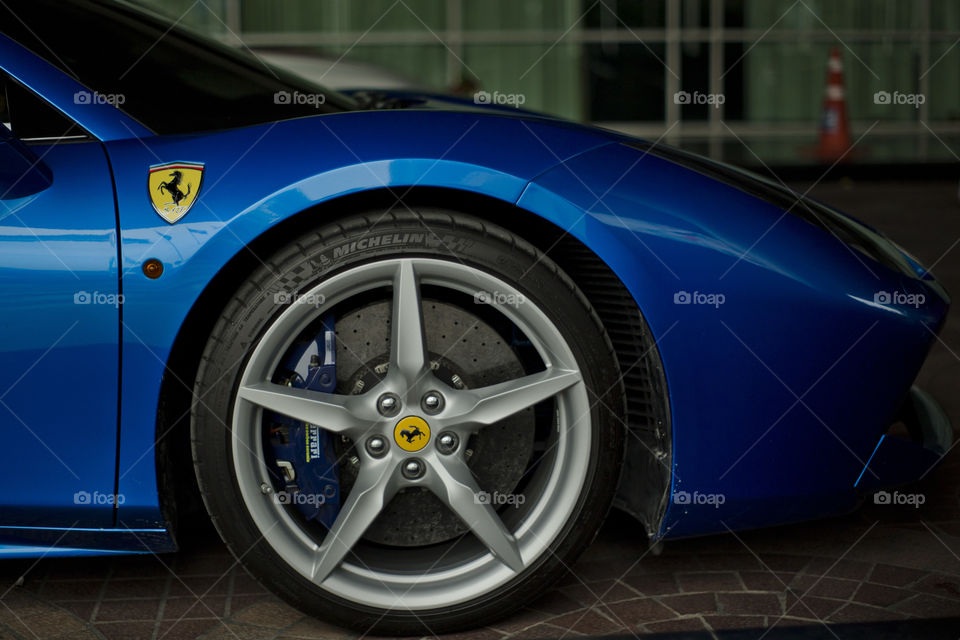 close up front view logo rim of Ferrari 488 spider blue coupe sports car, 3.9 liter V8 twin turbocharged produced by the Italian sports car - Ferrari F154CB V8