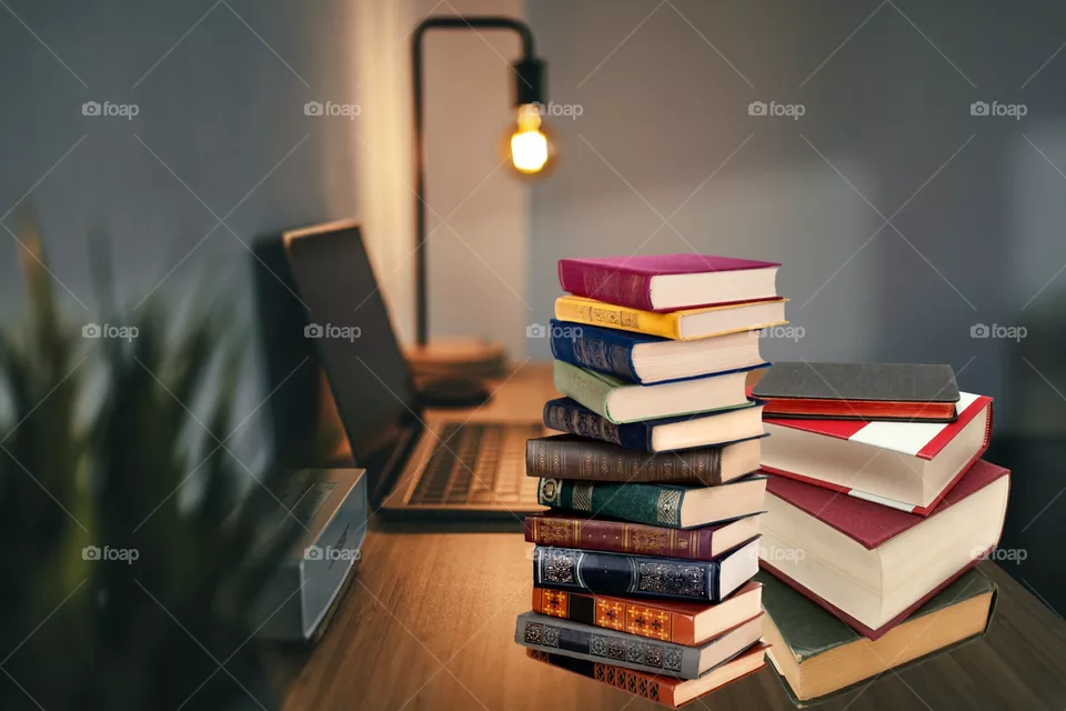 desk with laptop and books