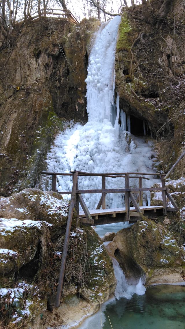 Frozen waterfall And a beautiful wooden bridge