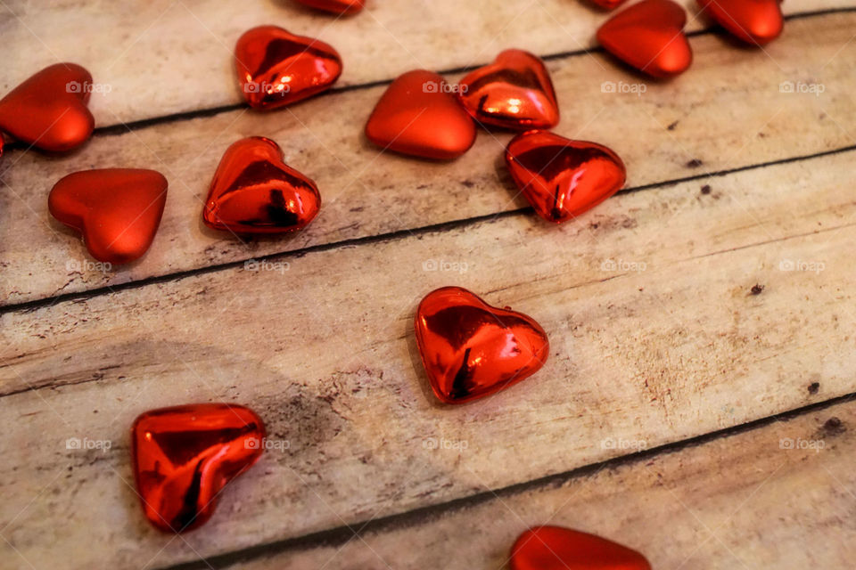 Red hearts on wooden table