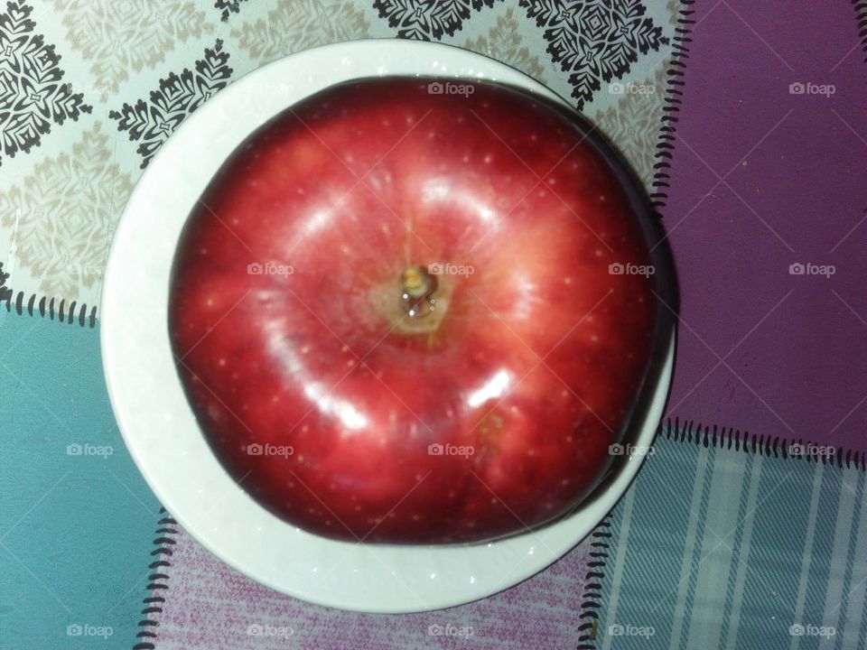 Delicious apple in a plate.