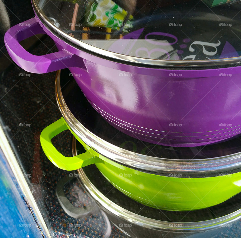 Stack of casseroles in a shop's window
