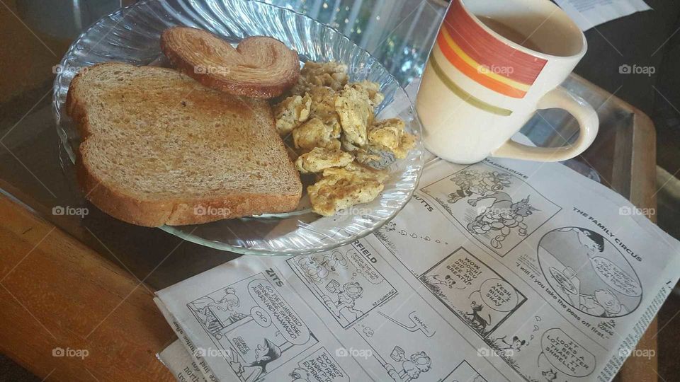 Early morning Breakfast, and newspaper,  acting like an adult.