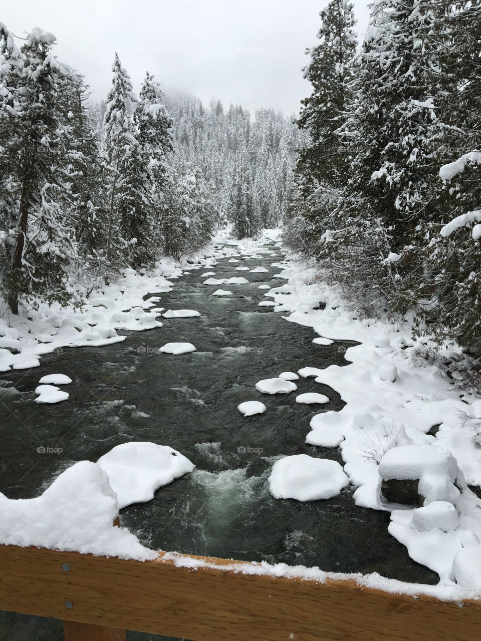 Mountain creek in winter with snow