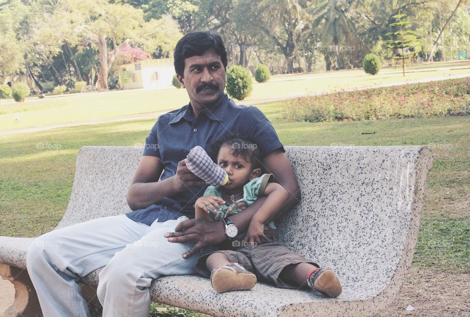 Father feeding his son