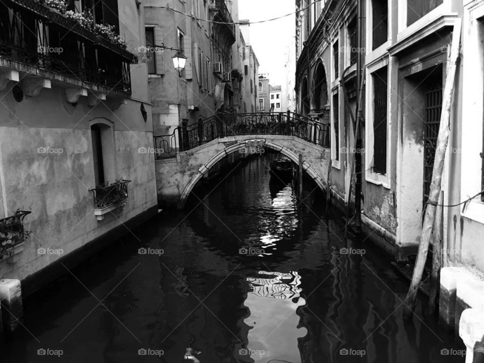 The drowned streets of Venice with bridge in street.