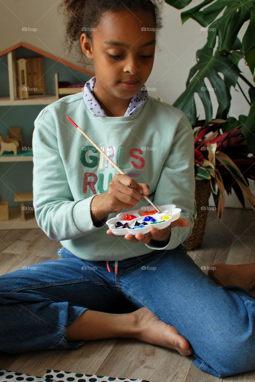 Teenage girl of mixed race painting
