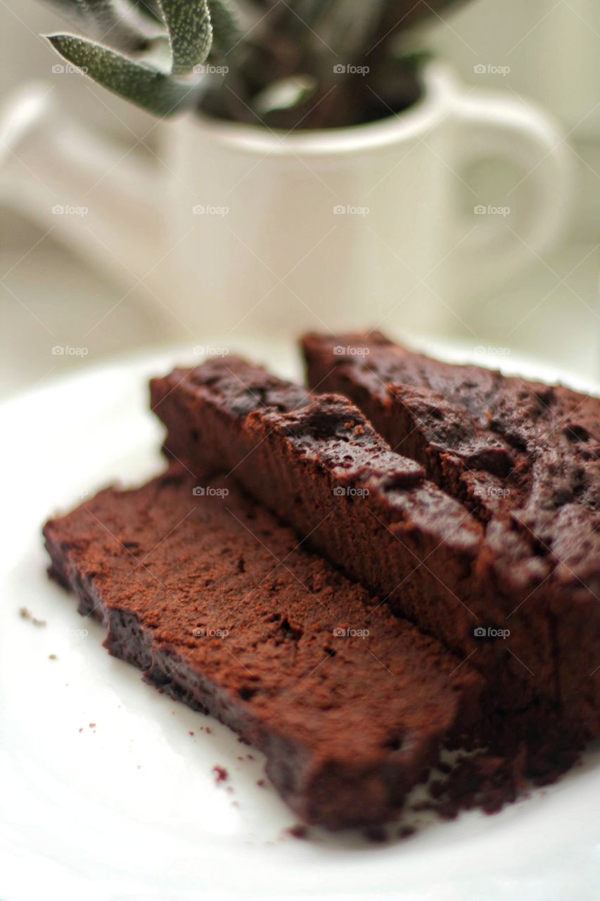Sliced ​​brownie on a white plate