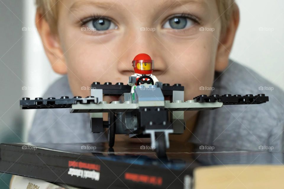Lego aircraft and a portrait in background