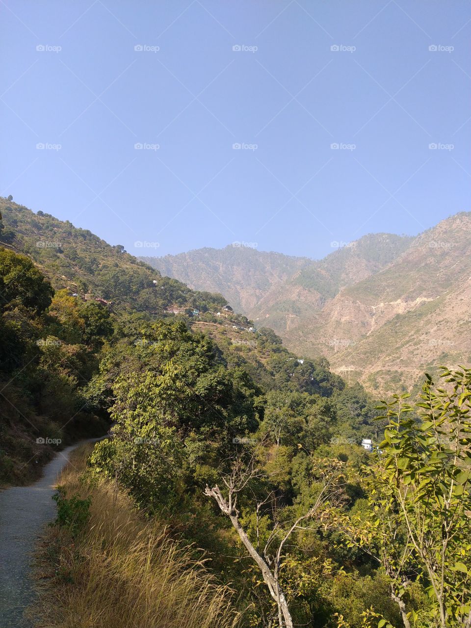 A distant view of my village surrounded by hills and mountains