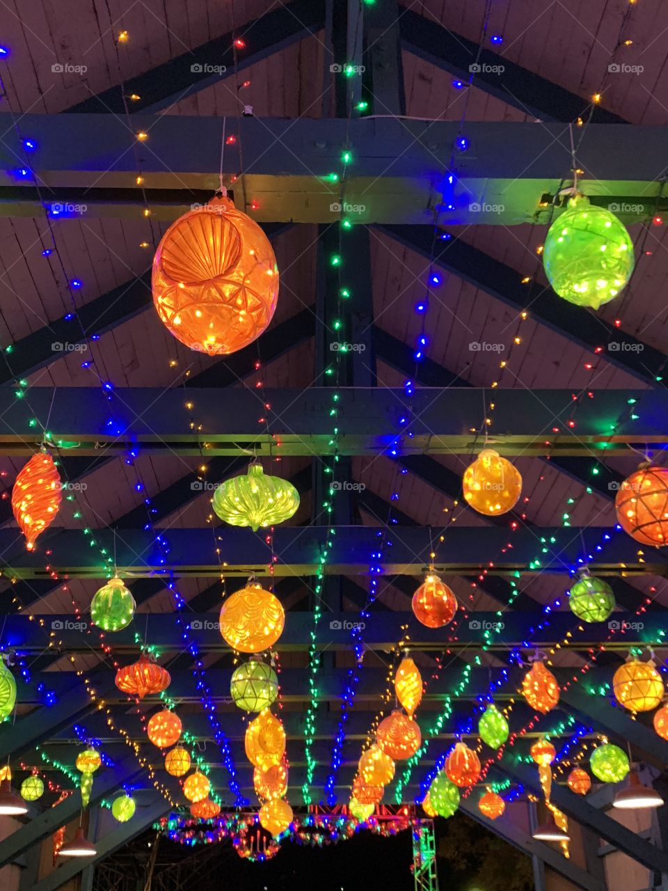 A roof lined inside with Christmas ornament lights in vibrant colors 