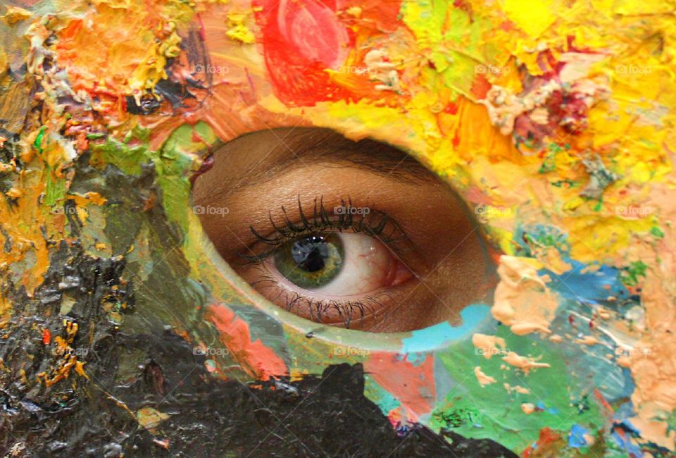 Eye in a hole of colorful palette