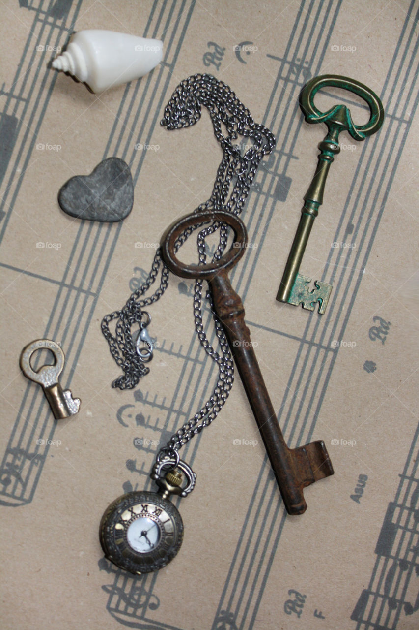 Old keys, stone heart, clock, old paper, music sheets