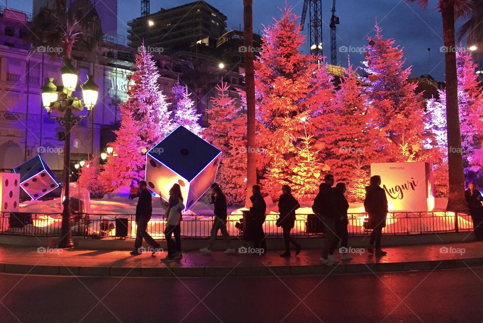 Christmas city lights in Monaco Monte Carlo and unrecognizable pedestrian people silhouettes 