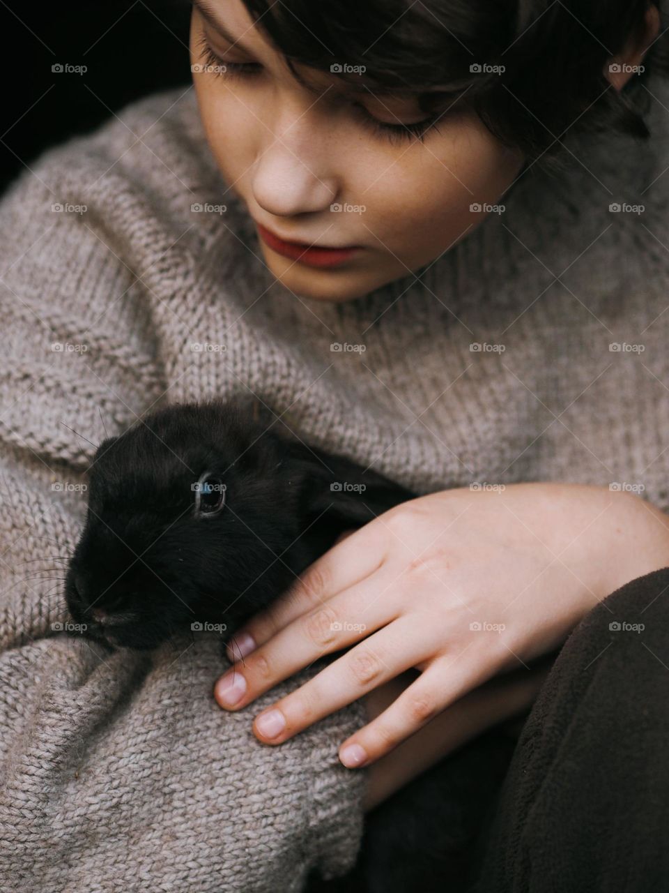 Cute little boy with black rabbit 