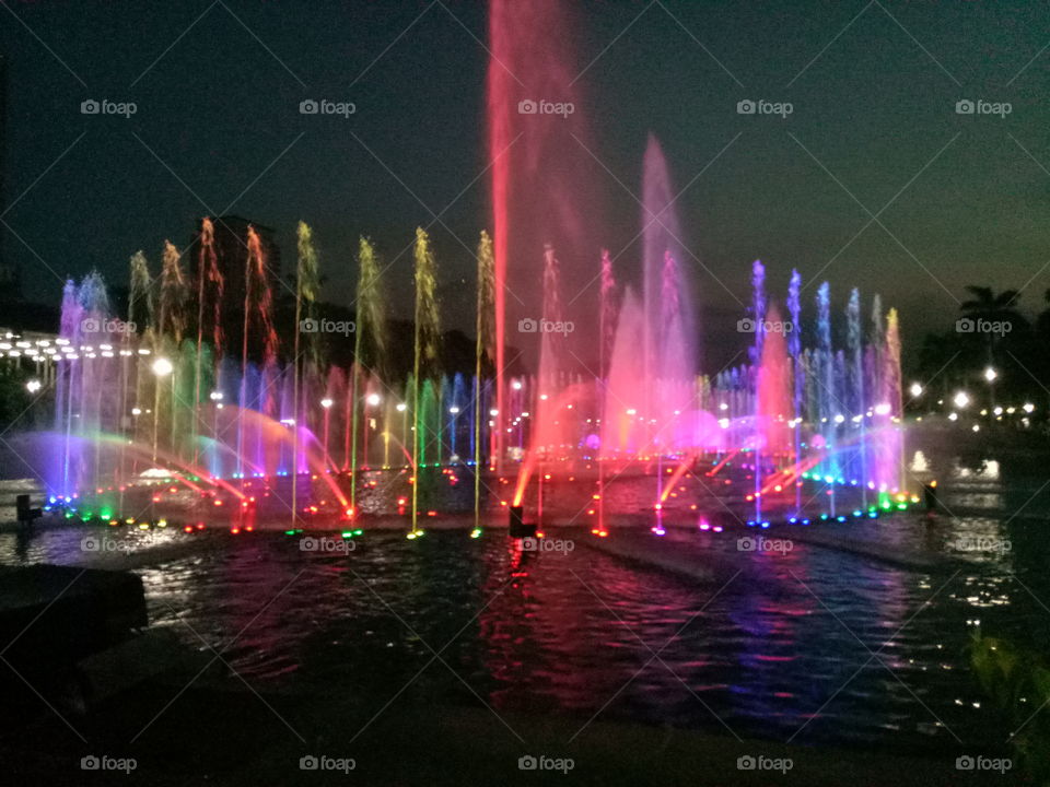 a colorful dancing fountain in luneta park.