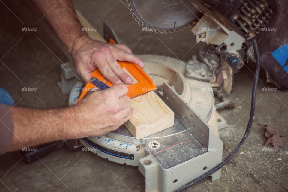 A person marking on wood material