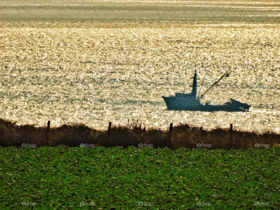 Fishing boat at sea during sunset