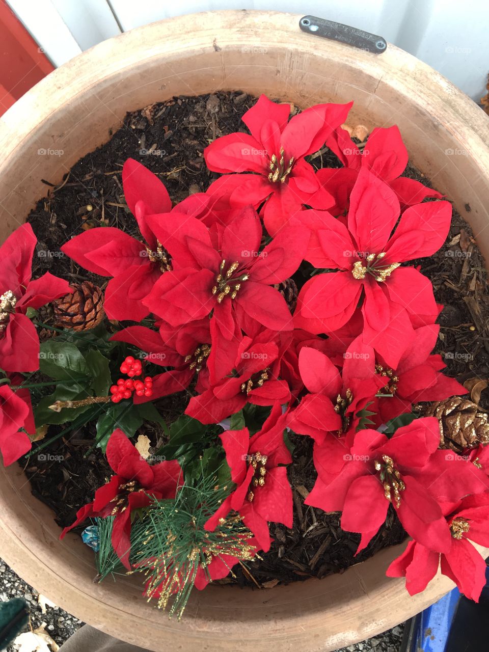 Fake poinsettias in a round planter showing off the holidays spirit! Let’s celebrate!